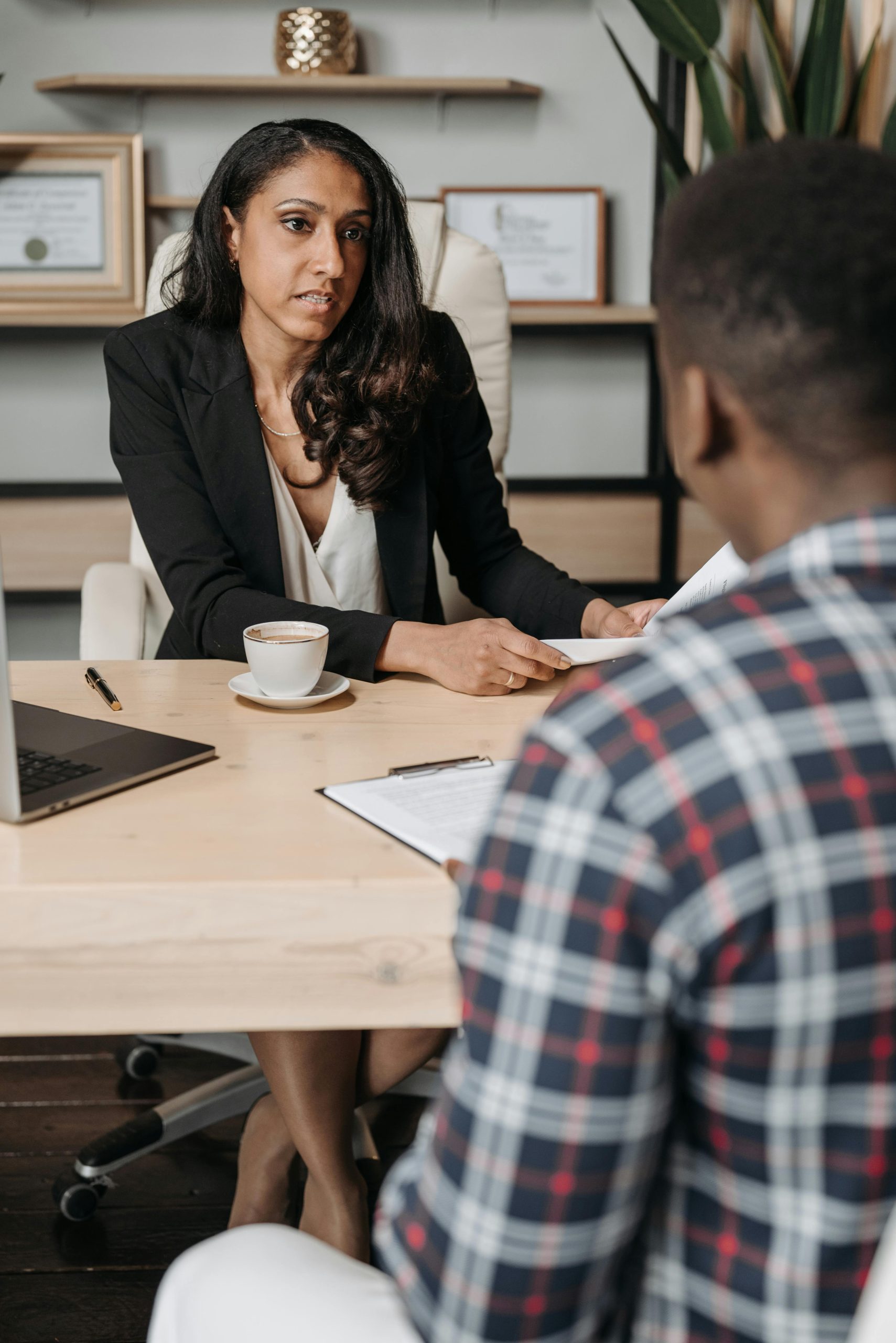 Professional discussion between consultant and client in a modern office setting.